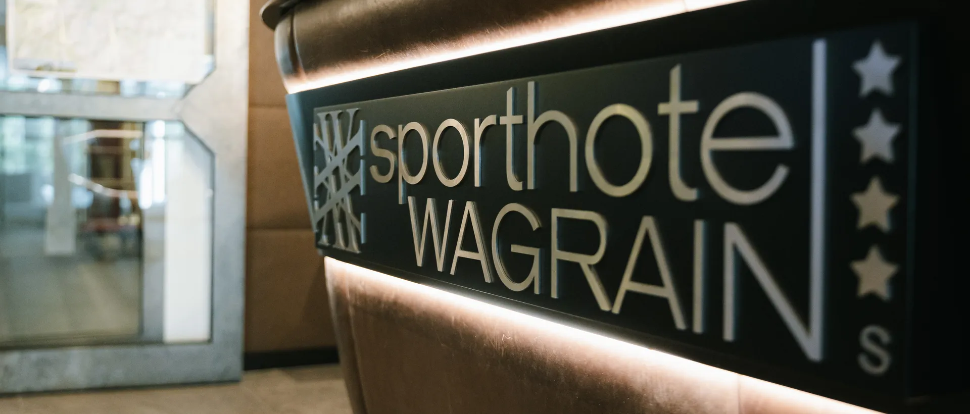 Illuminated sign Sporthotel Wagrain at brown reception
