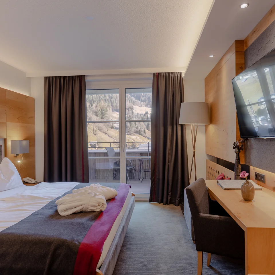 Modern hotel room with balcony and mountain view
