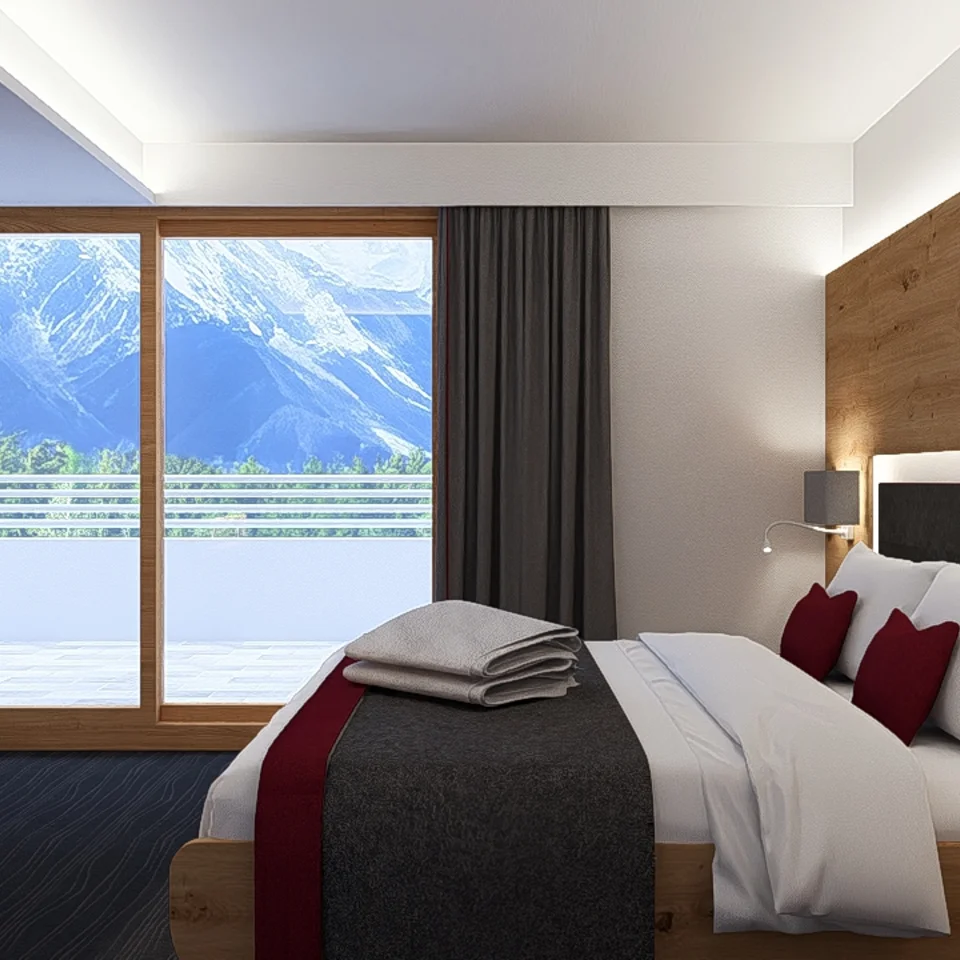 Modernes Hotelzimmer mit Bergblick durch großes Fenster