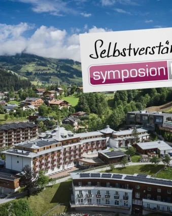 Sporthotel Wagrain mit Logo Symposion Hotels vor Berglandschaft