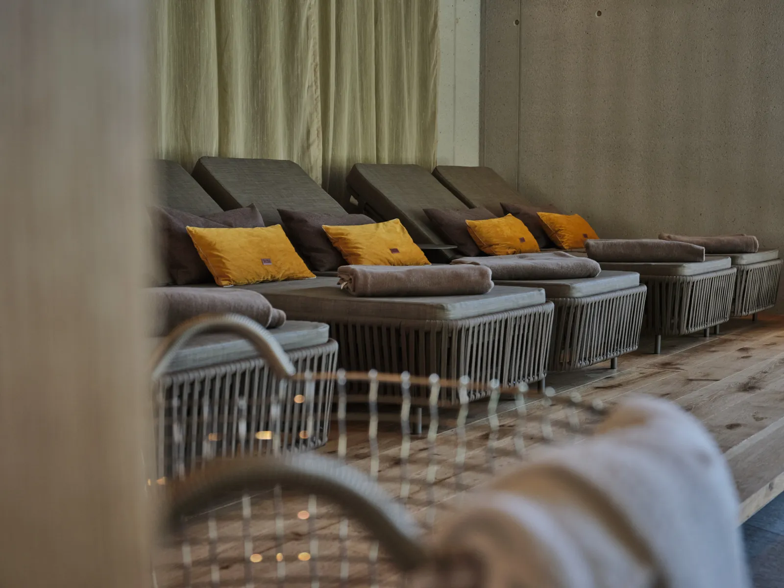 Grey loungers with yellow cushions in a relaxation room