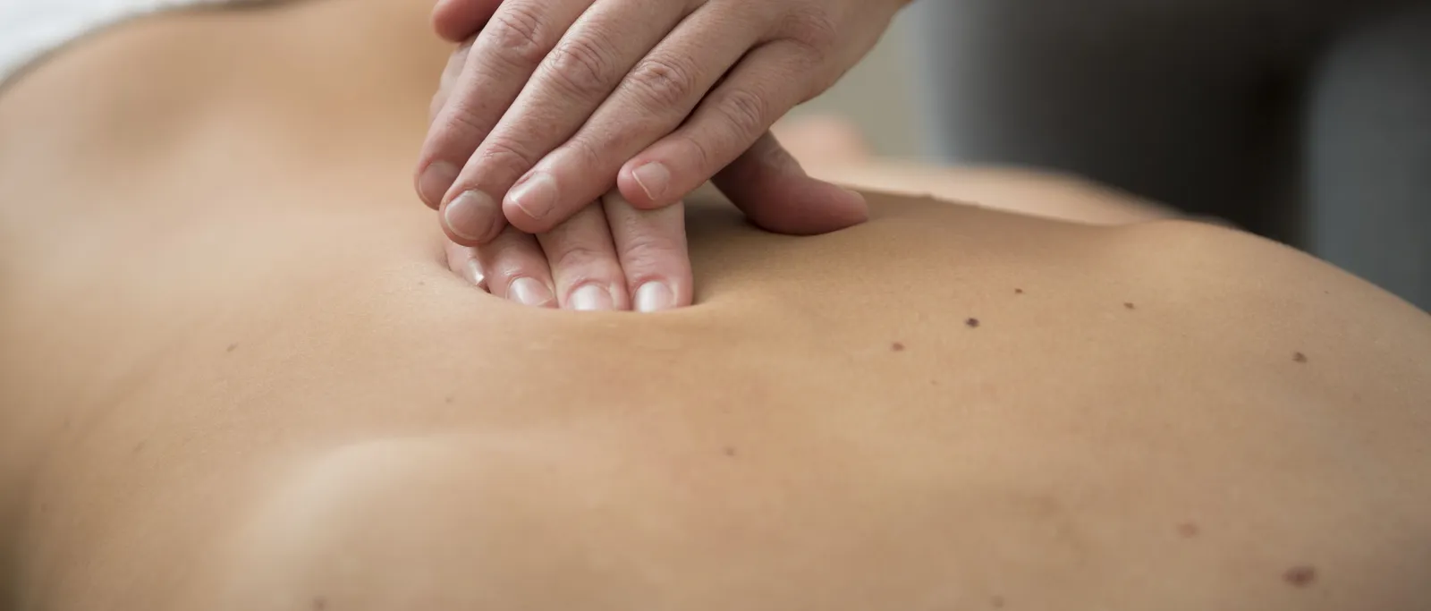 Hands massaging a back