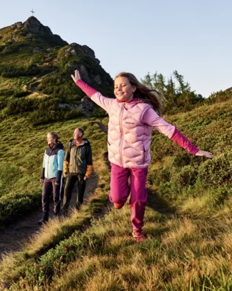Hiking family on mountain trail in front of the Griessenkareck in Wagrain